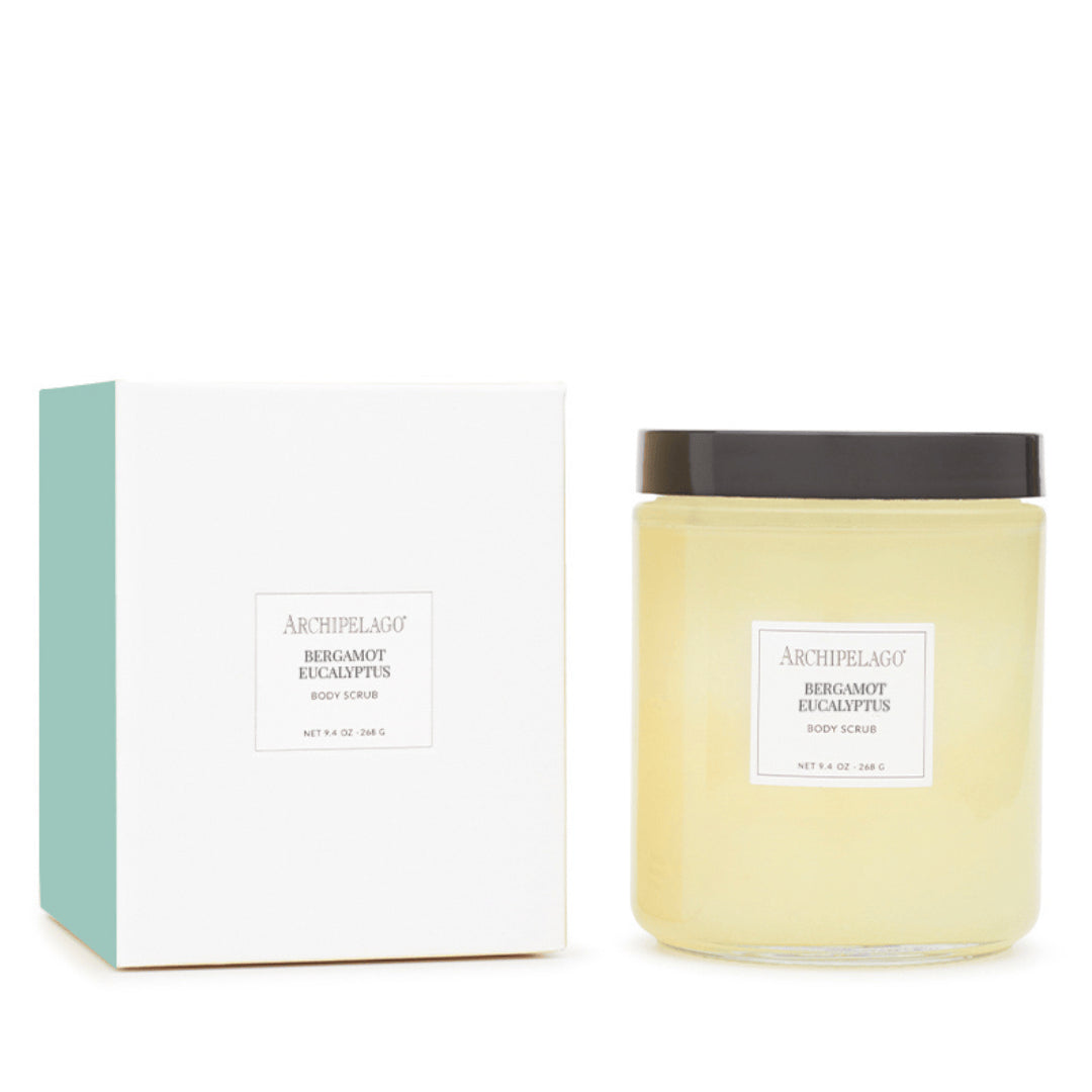 A jar of Bergamot Eucalyptus Body Scrub, enriched with natural oils, sits beside its white and teal packaging box—both bearing the product name in minimalist black text—making it an inviting addition to any self-care routine. - image 1