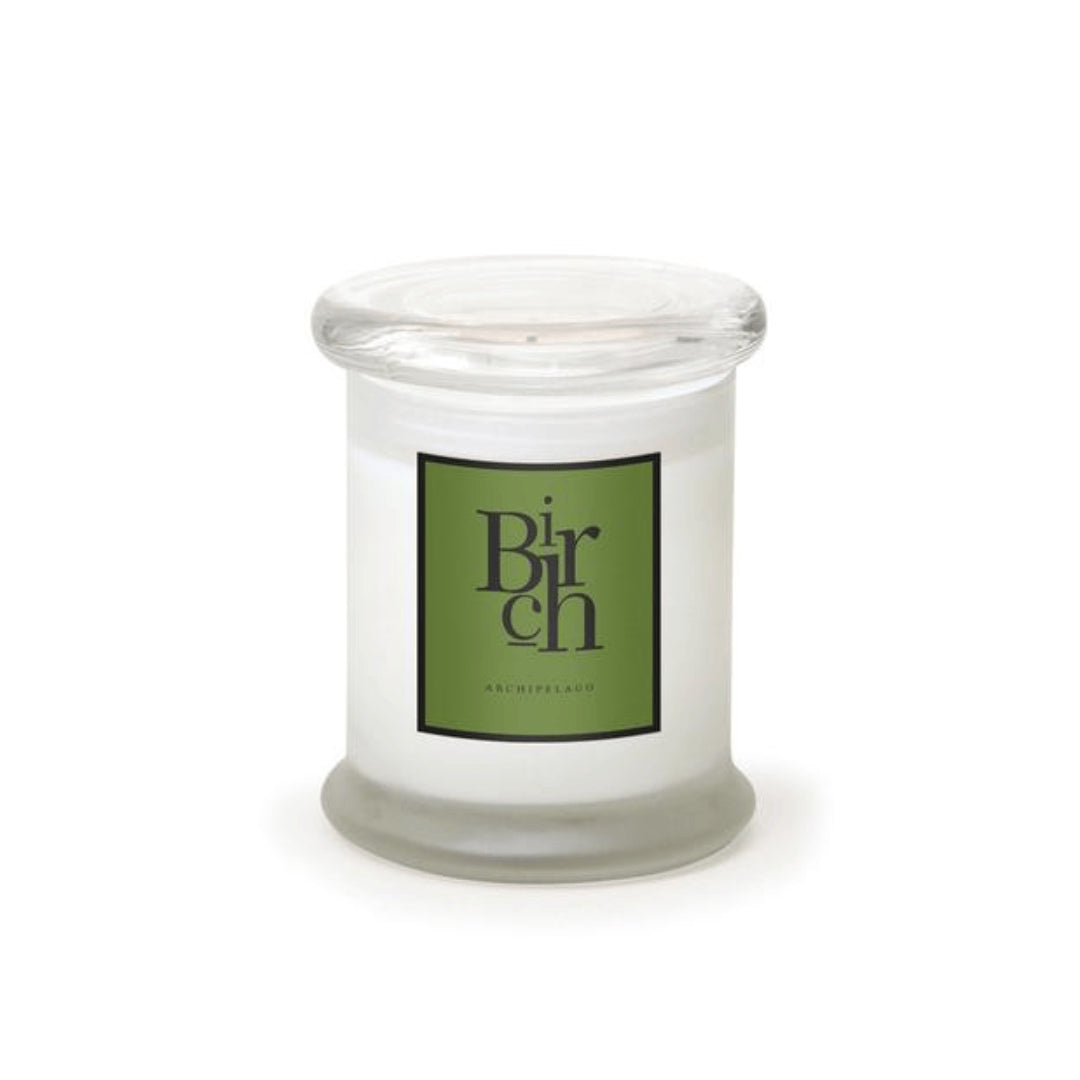 The Birch Frosted Jar Candle features soy wax in a clear glass jar with a wide, flat lid. Its green label boldly displays "Birch," emphasizing the candle’s elegant design. - image 1
