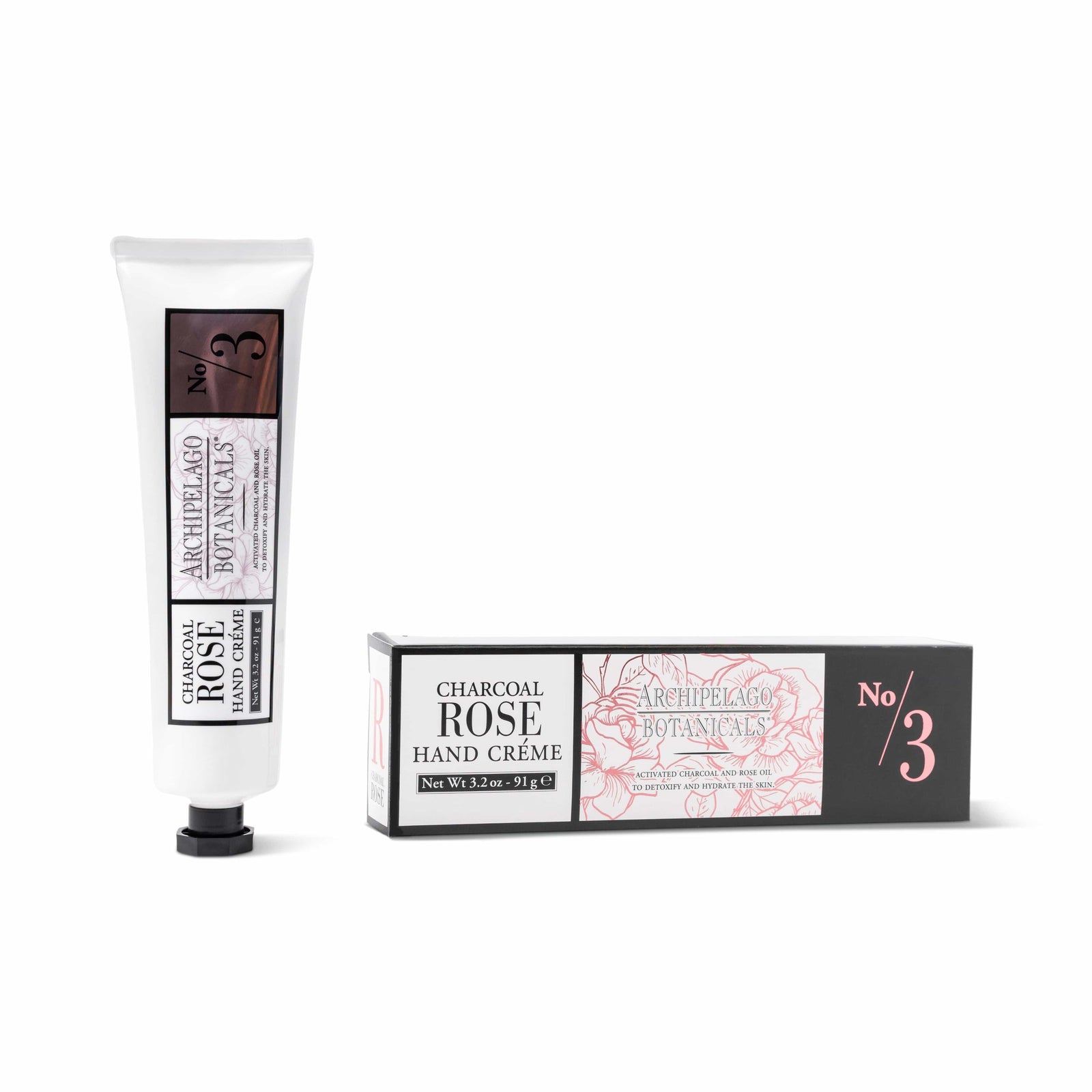 A tube and box of Charcoal Rose Hand Creme, 3.2 oz., featuring white, black, and pink packaging adorned with floral designs and product details—an ideal choice to elevate your moisturizing routine with this luxurious hydrating hand cream. - image 1