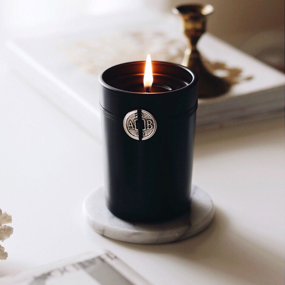 A lit Black Forest Candle with a single flame. - image 2