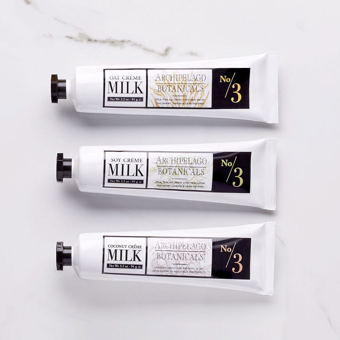 Three tubes of Archipelago Botanicals Soy Milk Hand Crème—ideal additions to your skincare routine—are displayed horizontally on a white surface. Each white tube features a black cap and a gold-accented label reading No 3, emphasizing luxurious ingredients such as nourishing soy extract. - image 2