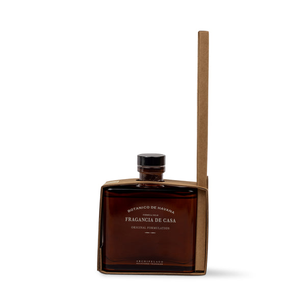 A square amber glass Botanico de Havana Reed Diffuser bottle nestled in a minimalist brown cardboard sleeve.