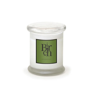 The Birch Frosted Jar Candle features soy wax in a clear glass jar with a wide, flat lid. Its green label boldly displays "Birch," emphasizing the candle’s elegant design.1