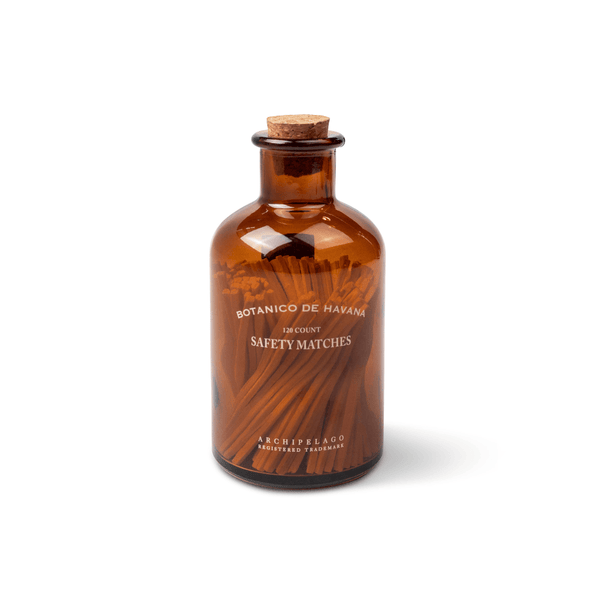 Brown glass bottle with cork lid on a white background