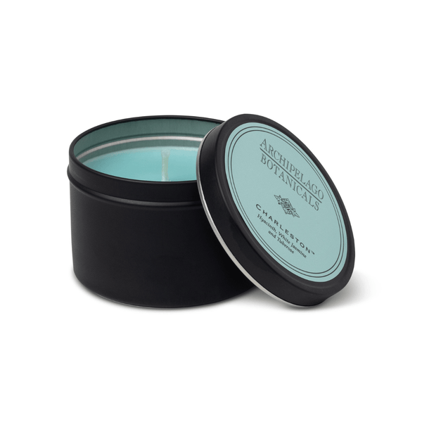 Black candle tin with a light blue candle inside, featuring 'Archipelago Botanicals' branding.