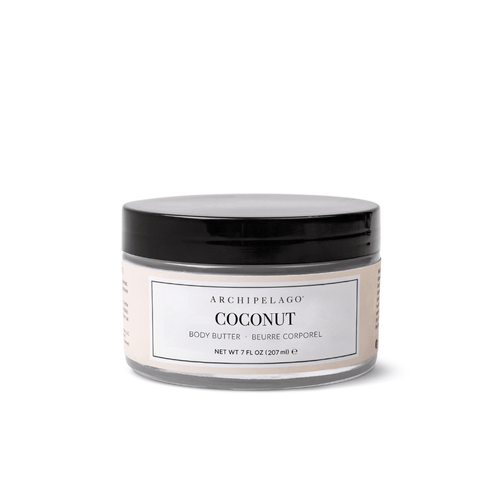 A 7 fl oz (207 ml) jar of Coconut Body Butter with a black lid and white label, enriched with coconut oil for moisturizing. The label features English and French text.