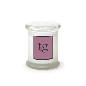 The Fig Frosted Jar Candle is a white candle in a frosted glass jar with a clear lid. It features a mauve front label with "fig" in lowercase black letters on a white background, giving it a modern look.1