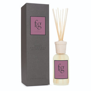 The Fig Reed Diffuser features a glass bottle with wooden cap and reed sticks, labeled fig fragrance, next to a sleek dark box with Fig and Archipelago branding—a modern home fragrance diffuser.1