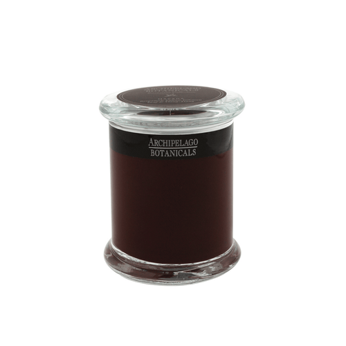 A dark red Havana Jar Candle by Archipelago Botanicals sits in a clear apothecary jar with a flat glass lid, displayed against a plain white background.