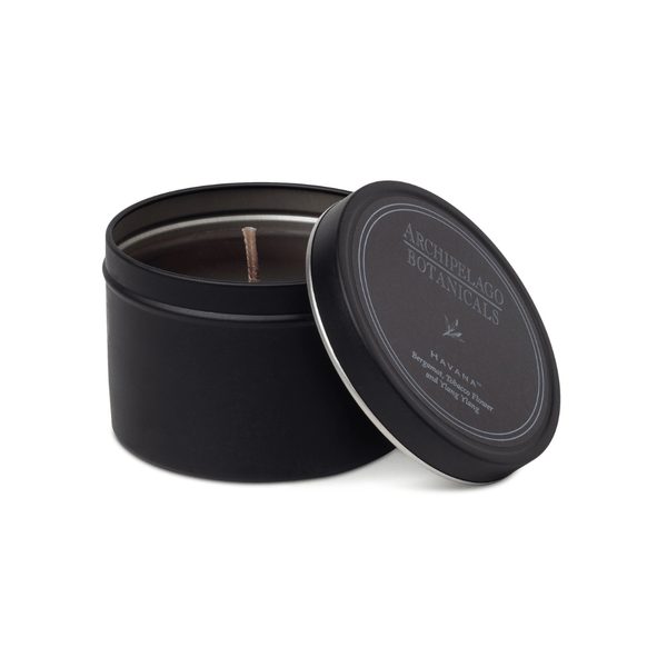 Black candle tin with lid on a white background