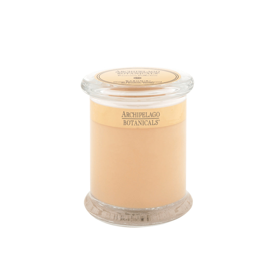 A beige Kashmir Jar Candle in a clear glass jar with a lid, labeled "Kashmir Jar Candle" by Archipelago Botanicals on the front and top.1