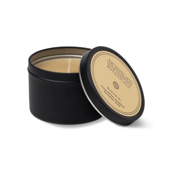 Black candle tin with beige label on a white background