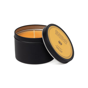 Black tin candle with a yellow label on a white background1