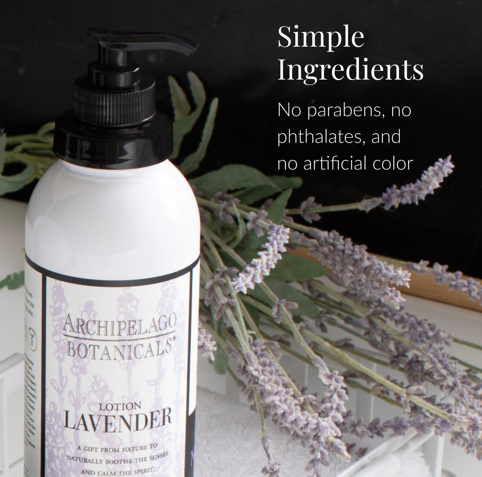 A bottle of Lavender Body Lotion sits on a white tray with sprigs of lavender behind it. Infused with essential oils, this moisturizing lotion is made with simple ingredients—no parabens, no phthalates, and no artificial color.2