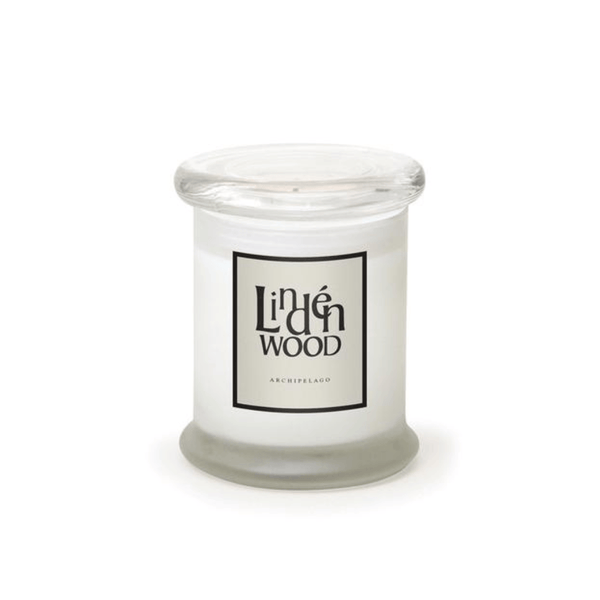 The Lindenwood Frosted Jar Candle features a glass jar with a clear lid, white premium wax, and a front label that says Linden Wood and Archipelago in black on white.