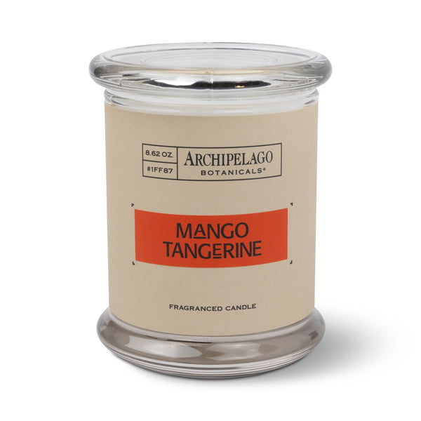 The Mango Tangerine Jar Candle features 8.62 oz of soy wax in a clear glass jar with a beige "Archipelago Botanicals Fragranced Candle" label and lid, filling your room with a refreshing citrus scent.