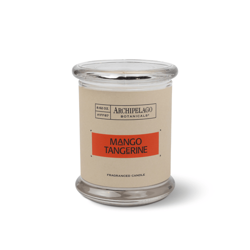 The Mango Tangerine Jar Candle, with a clear glass jar, tan label with orange stripe, and citrus-scented soy wax blend, is shown against a white background.