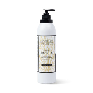 A white bottle of Oat Milk Body Lotion with a black pump top and a label adorned with gold botanical illustrations and product details.1