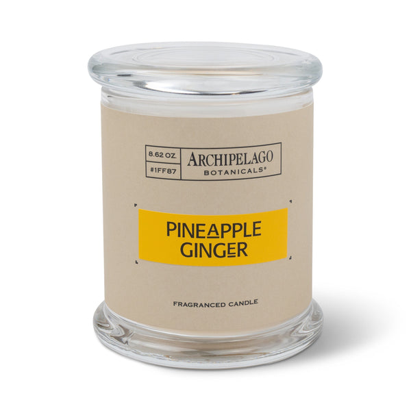 The Pineapple Ginger Jar Candle comes in a clear glass jar with a beige label that says "Archipelago Botanicals, Fragranced Candle, Soy Wax Blend." Weighing 8.62 oz, it features premium fragrance oils for an inviting aroma.