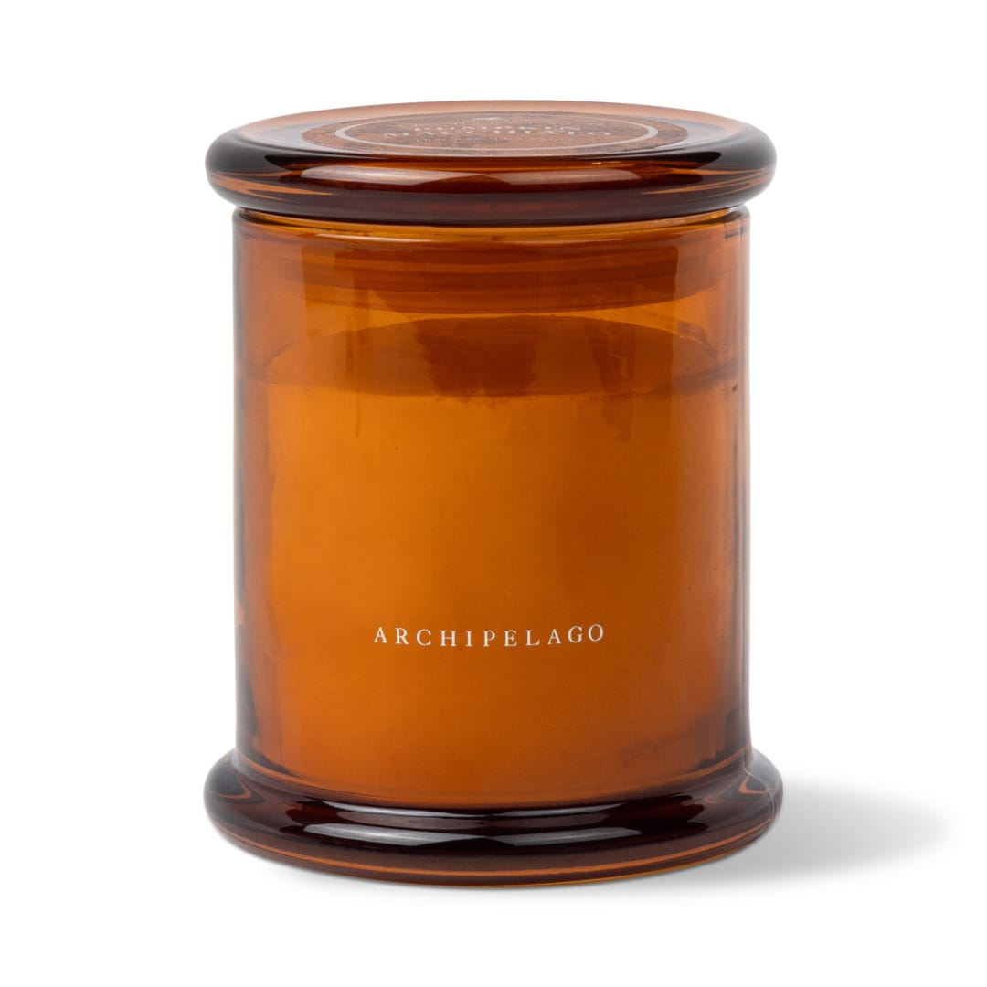 An amber glass jar candle with a matching amber lid, featuring the brand name 'ARCHIPELAGO' printed in white on the front, set against a clean white background. - image 4