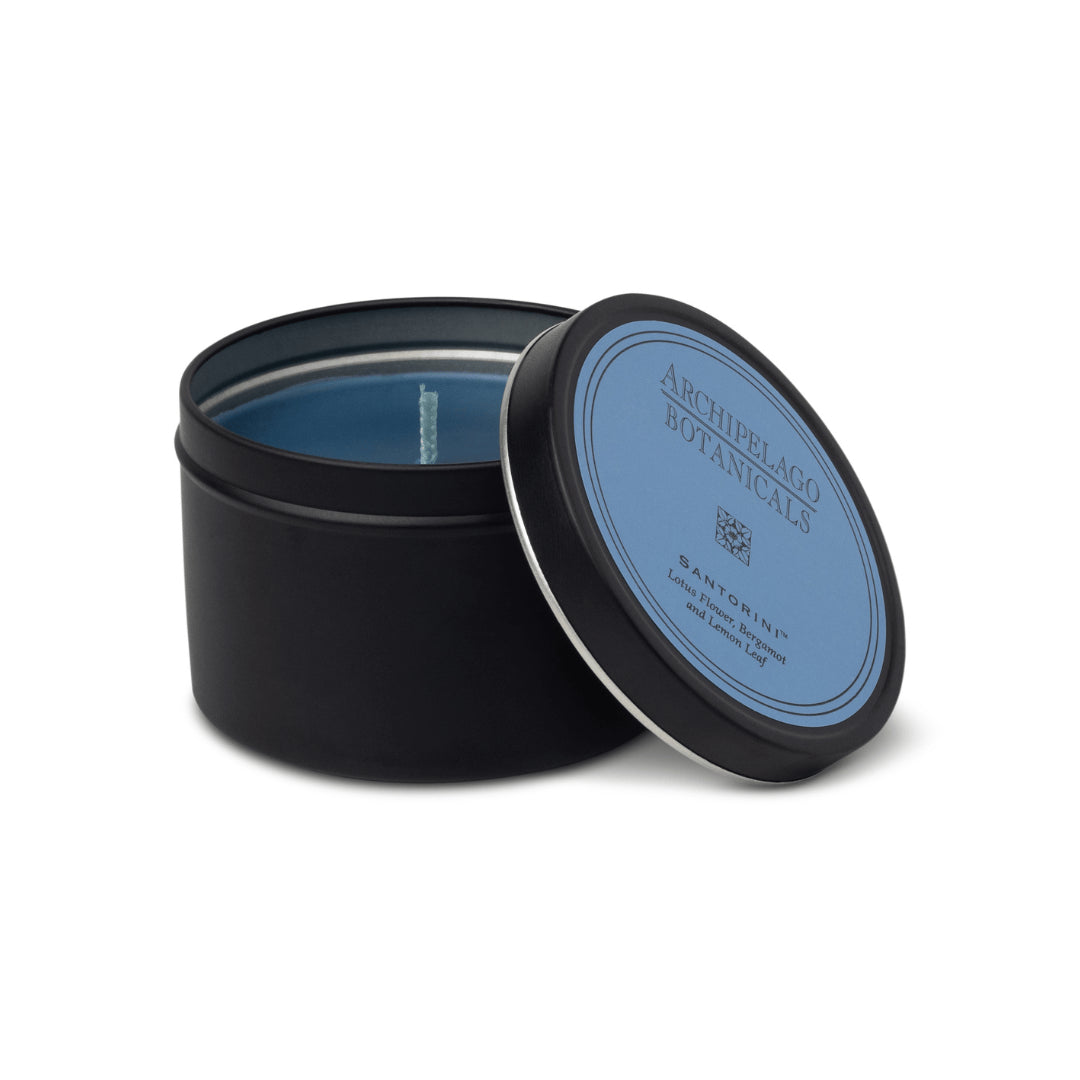 Black candle tin with blue lid featuring 'Archipelago Botanicals' on a white background1
