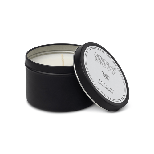 Black candle tin with a white candle inside, featuring Archipelago Botanicals branding.