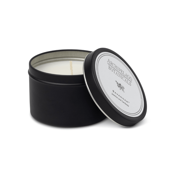 Black candle tin with a white candle inside, featuring Archipelago Botanicals branding.