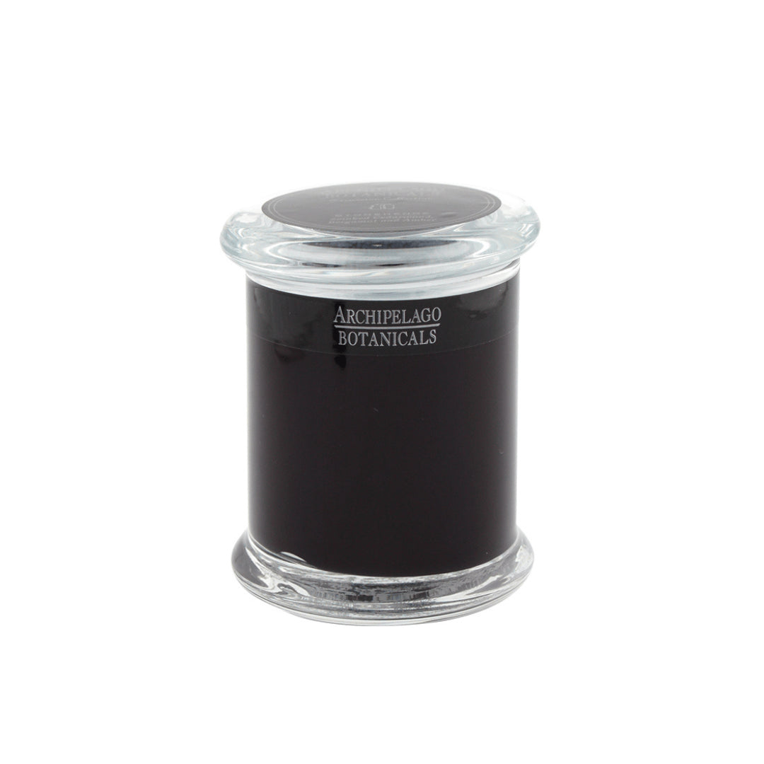A handcrafted Stonehenge Jar Candle in a clear glass jar with a matching lid features a dark-colored wax and an Archipelago Botanicals label on the front.1