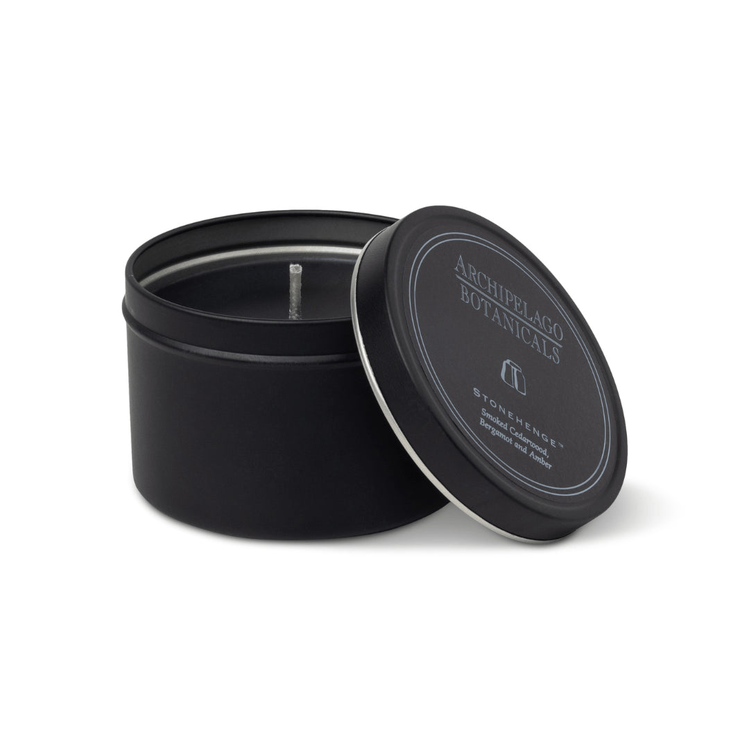 Black candle in a tin with 'Archipelago Botanicals' branding on a white background1