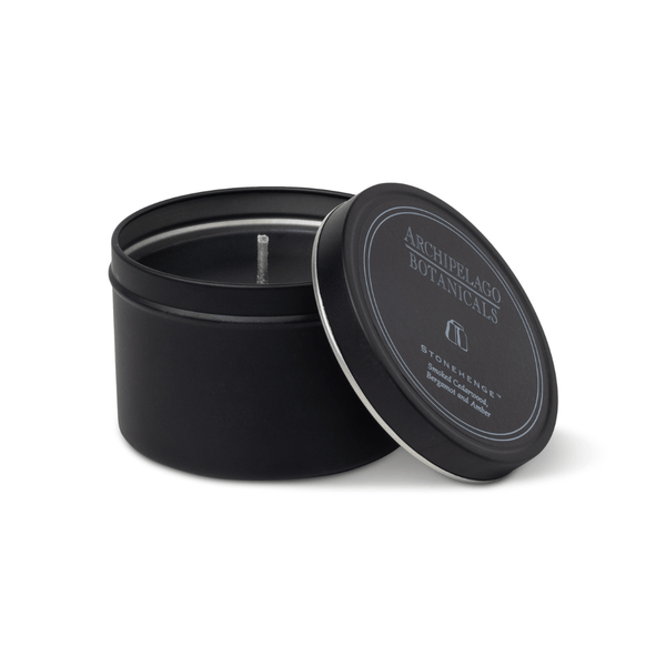 Black candle in a tin with 'Archipelago Botanicals' branding on a white background